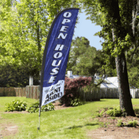 Custom Feather flags promoting an open house event in a residential yard