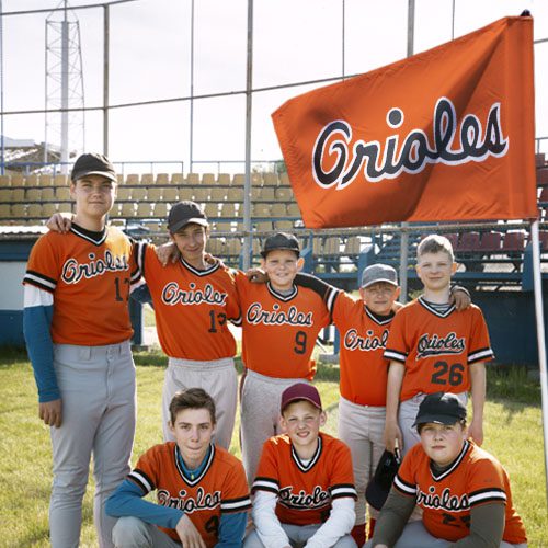 Custom baseball team flag for youth club with players posing proudly