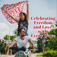 Couple waving a custom flag riding a motorcycle in a scenic outdoor setting