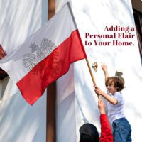 Young child helping hang a custom flag on house wall
