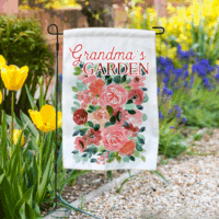 Garden flag in a flower bed with “Grandma’s Garden” floral design.