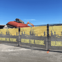 Custom mesh banner on construction site fence – wind-resistant outdoor advertising