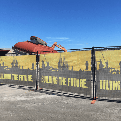 Custom mesh banner on construction site fence – wind-resistant outdoor advertising