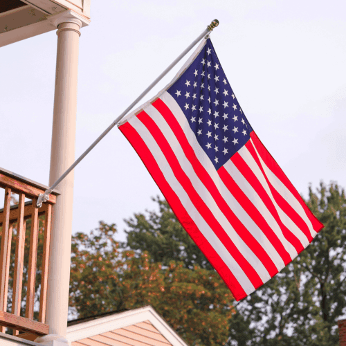6ft white spinning flagpole mounted on residential porch flying US flag