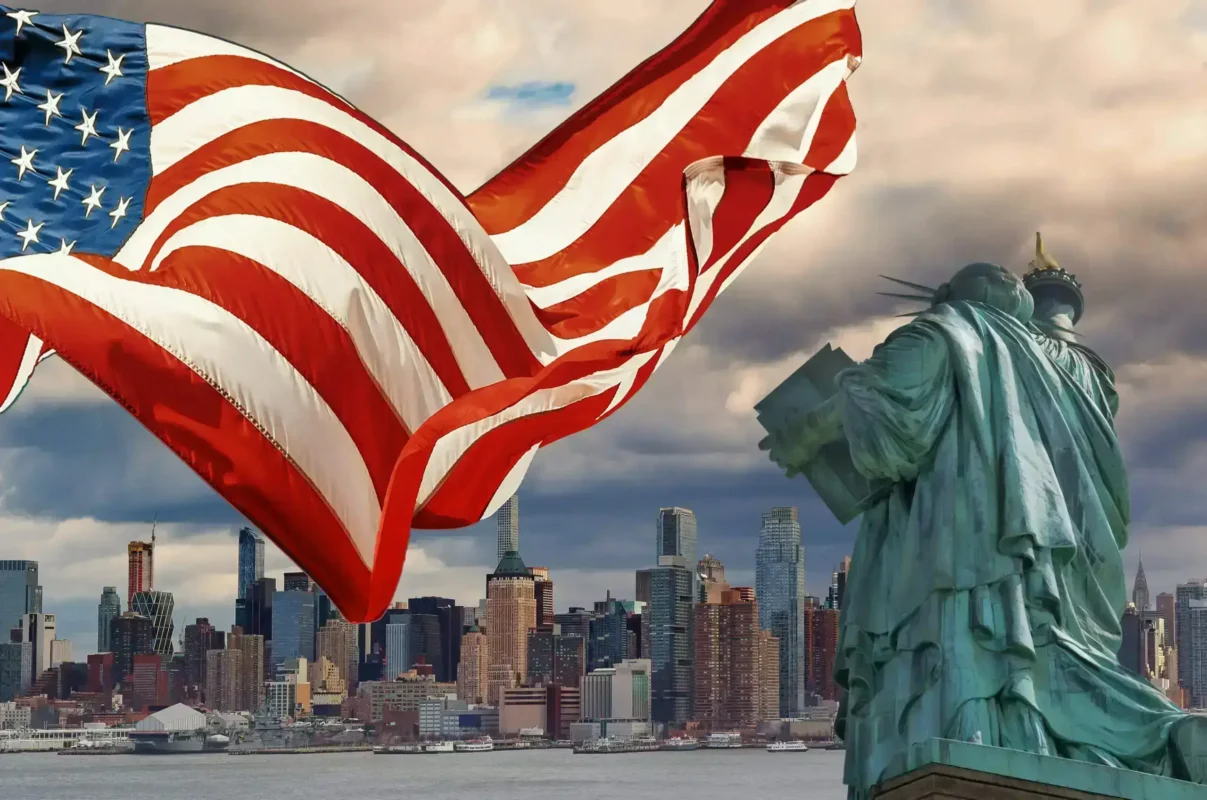Custom American flag waving with the Statue of Liberty – homepage hero banner for FlagStride's patriotic flag designs
